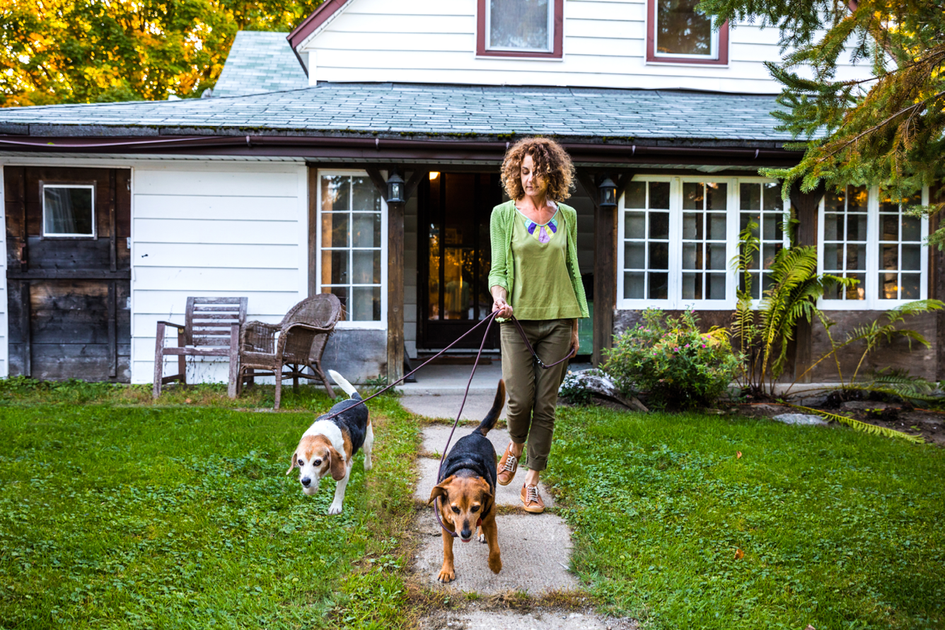 Woman takes dogs for a walk in the nature in Ontario, Canada.