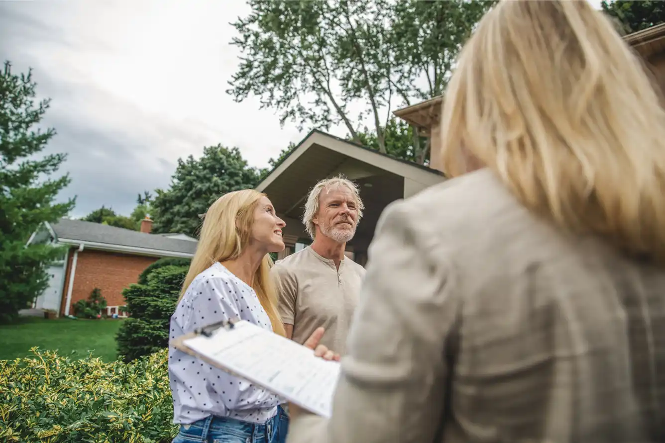 Couple in their 50s with a real estate agent looking at renting.