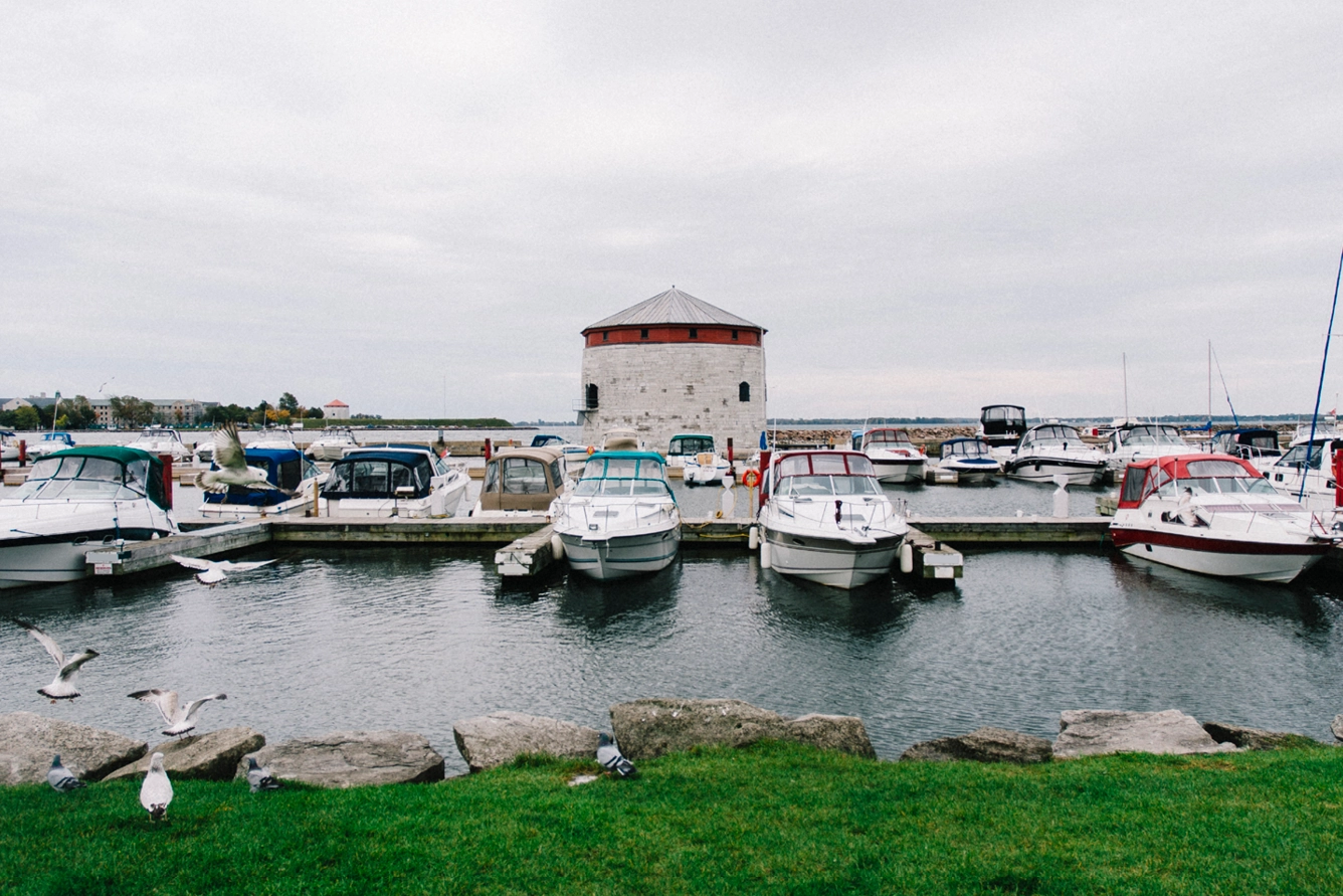 Modern boats moored in front of a Martello Towers in Kingston, Ontario, Canada.