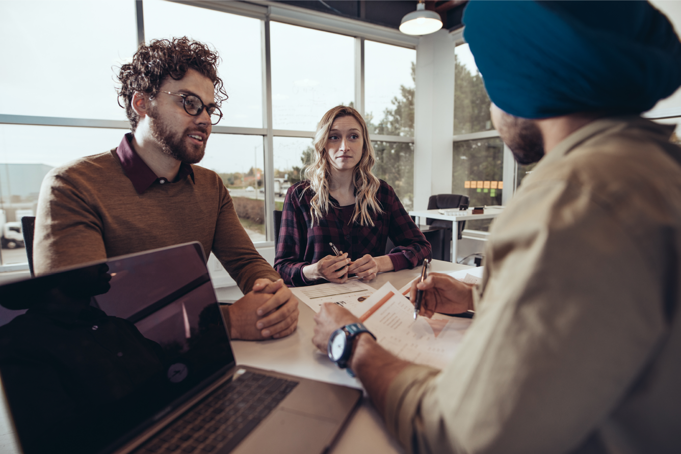 Two individuals meeting with an insurance broker