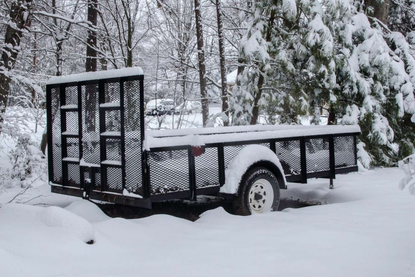 Utility trailer covered with snow.