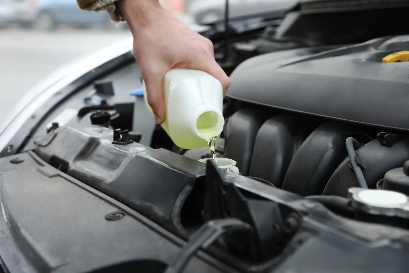 Adding fluids to a car as part of winter-proofing your automobile.