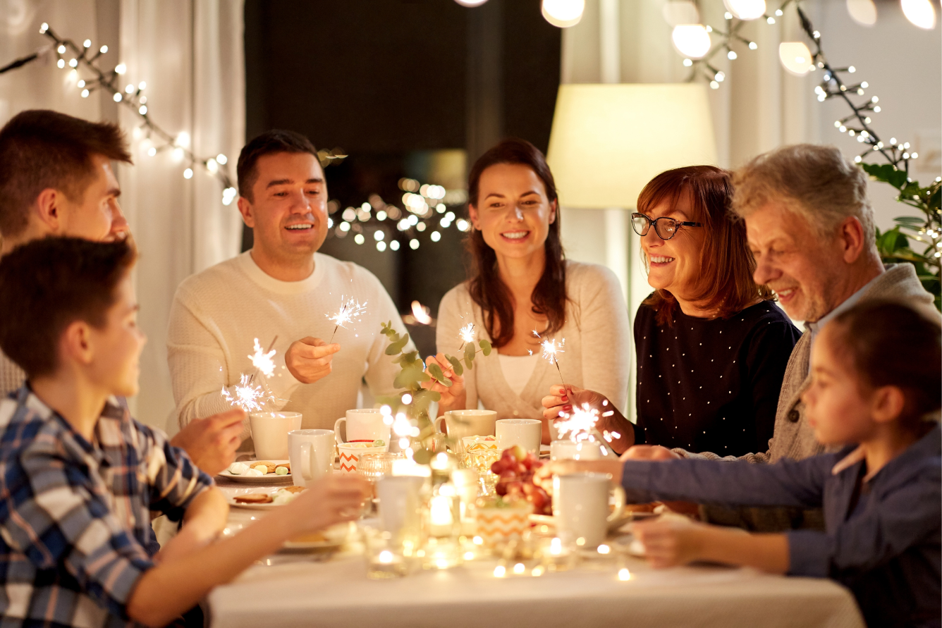 A group of people around a dining table with sparklers