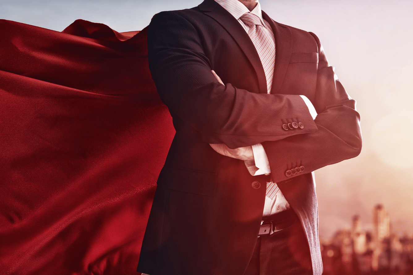 Insurance broker wearing a suit and cape.