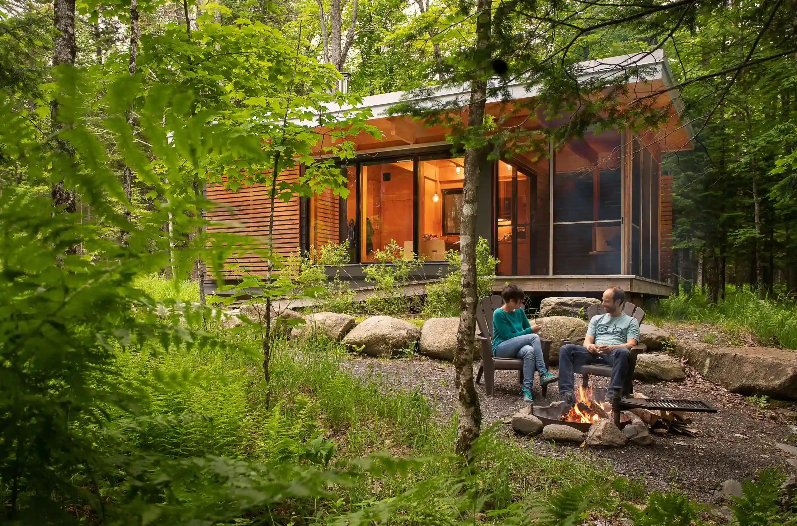 Couple relaxing together in front of their vacation house, enjoying a peaceful moment outdoors reflecting the comfort and security that vacation property firstontario insurance brokers helps maintain.