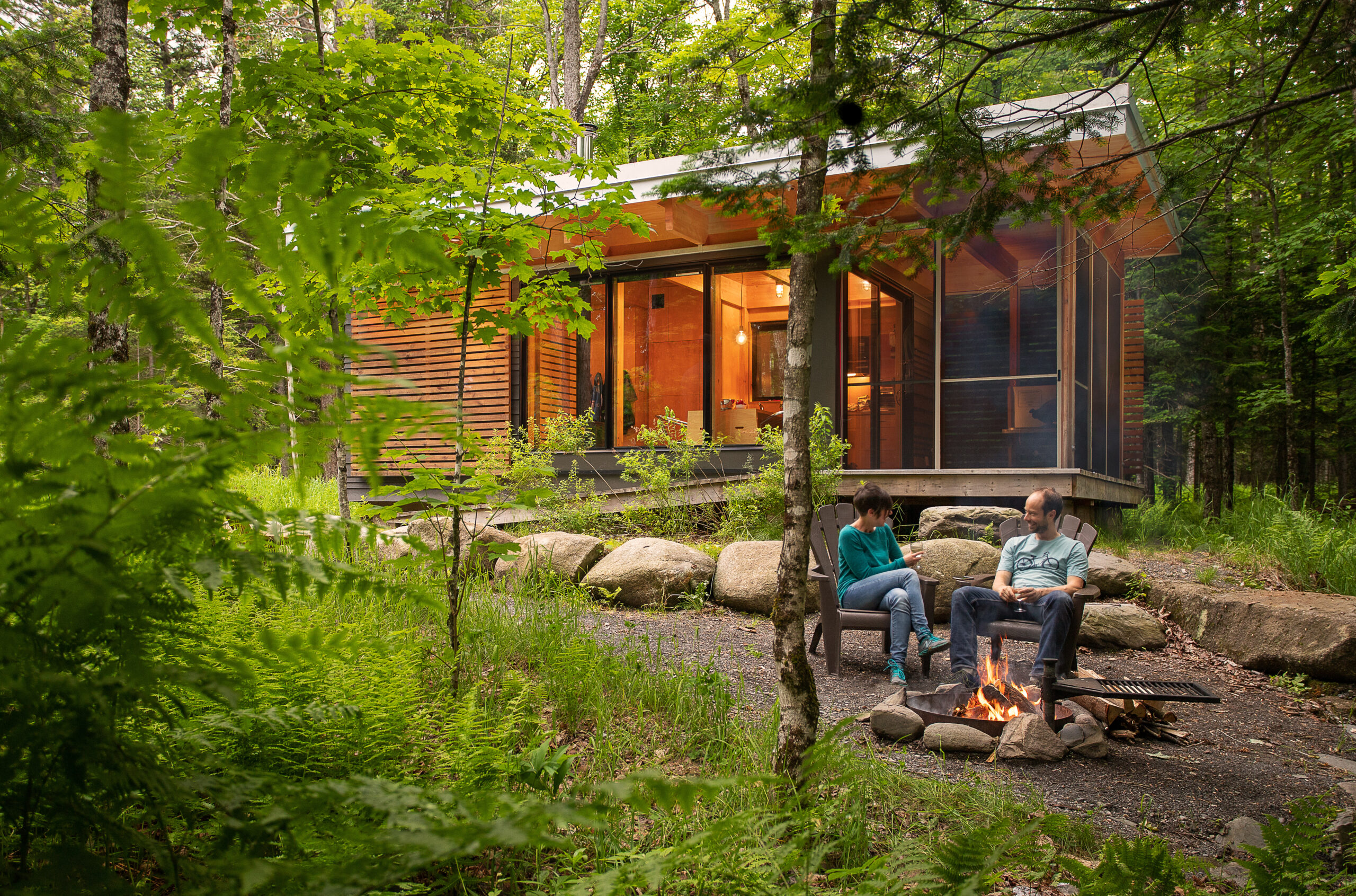 Couple relaxing together in front of their vacation house, enjoying a peaceful moment outdoors reflecting the comfort and security that vacation property FirstOntario Insurance Brokers helps maintain.