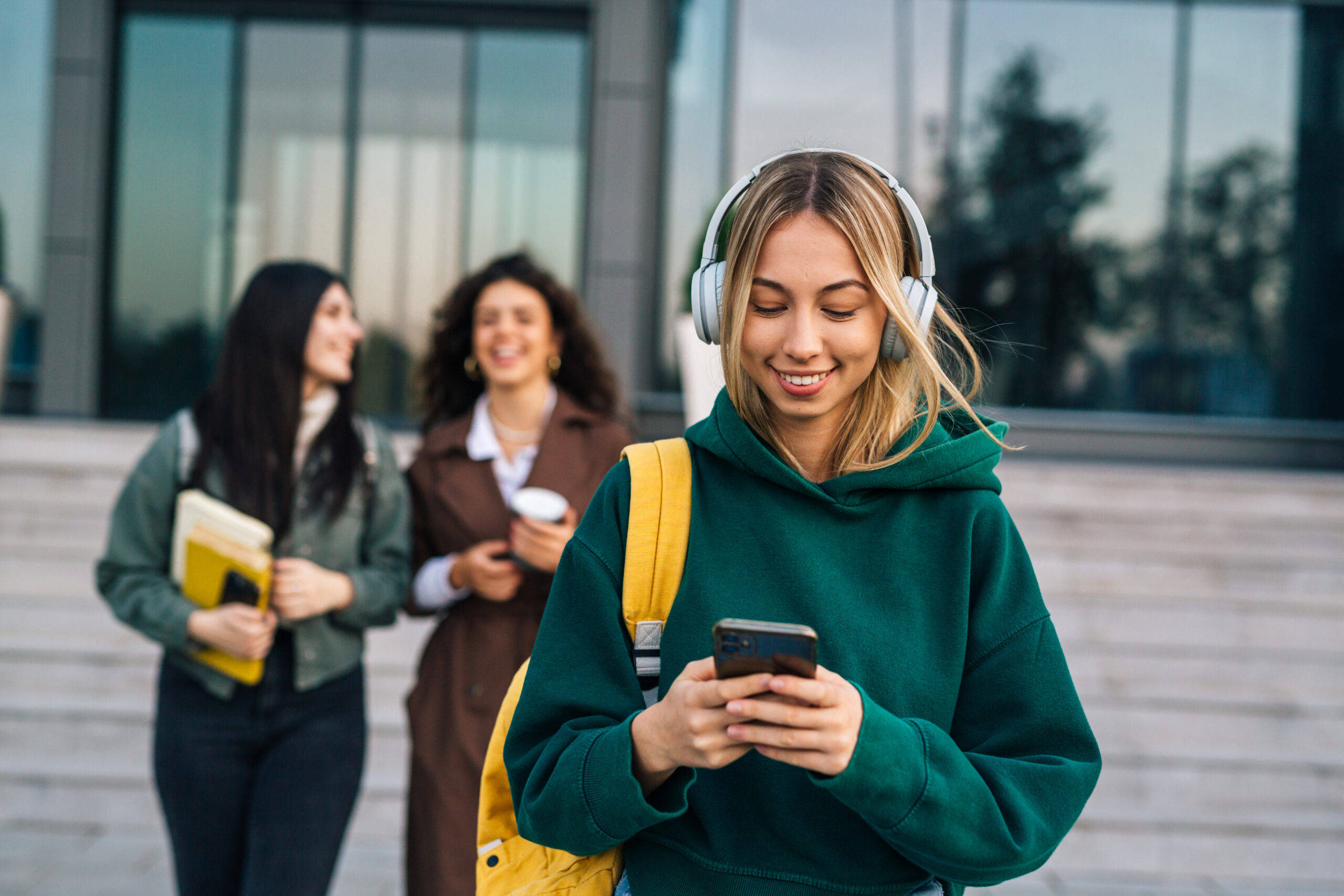 Group of college students walking through a vibrant campus, enjoying student life and heading to class symbolizing education, independence, and the college experience.