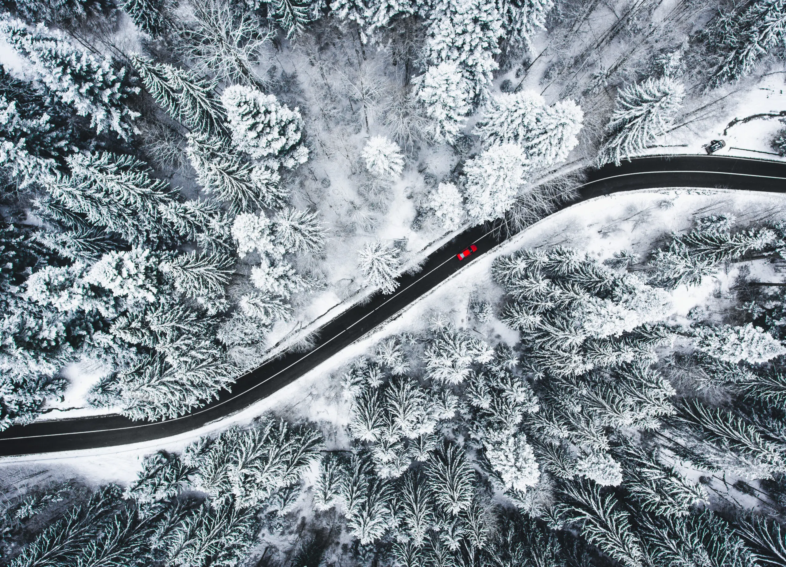 A vehicle navigating a snow-covered road, showcasing winter resilience and safety