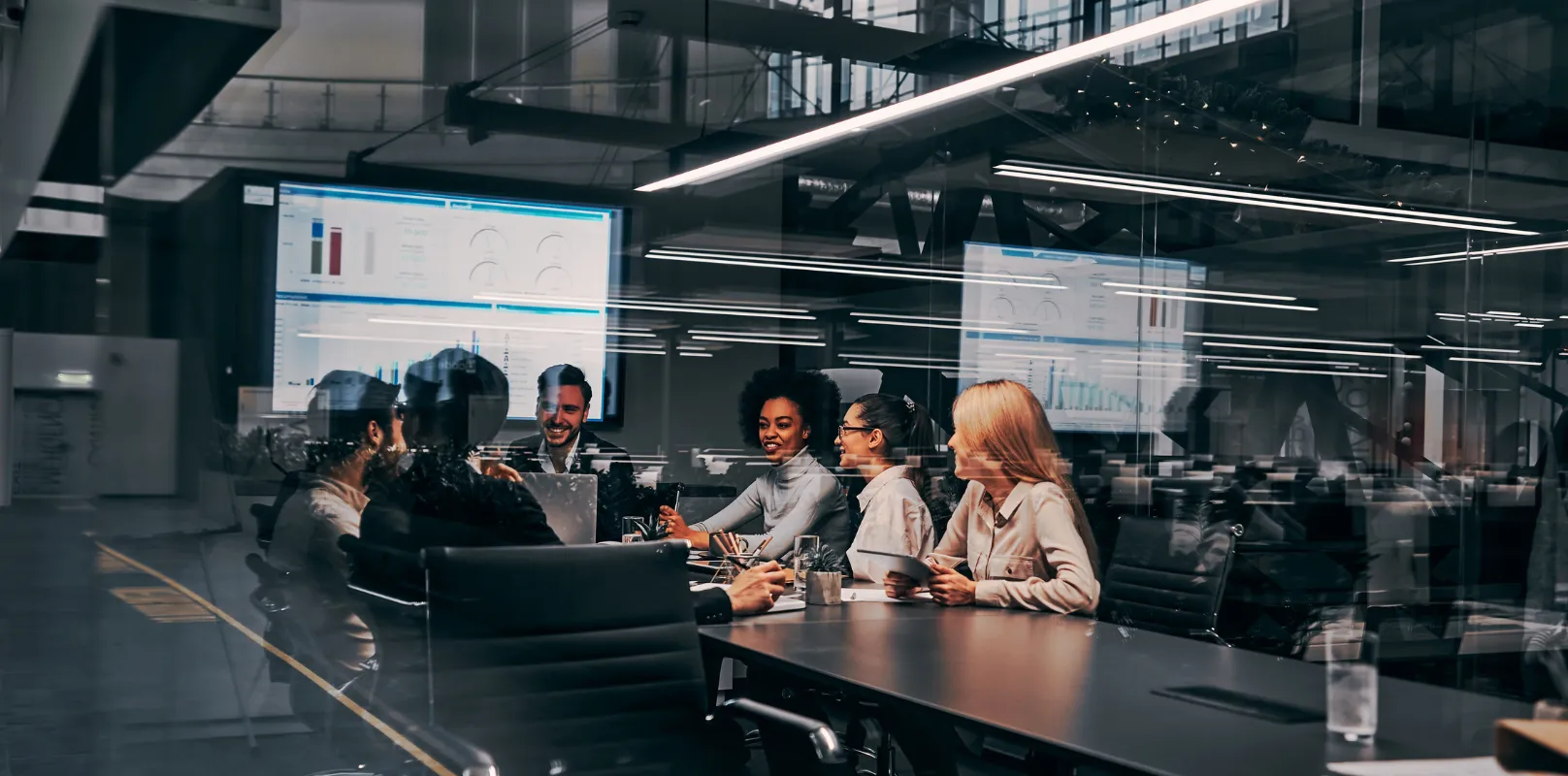 Business team gathered in an office for a meeting, discussing work around a conference table