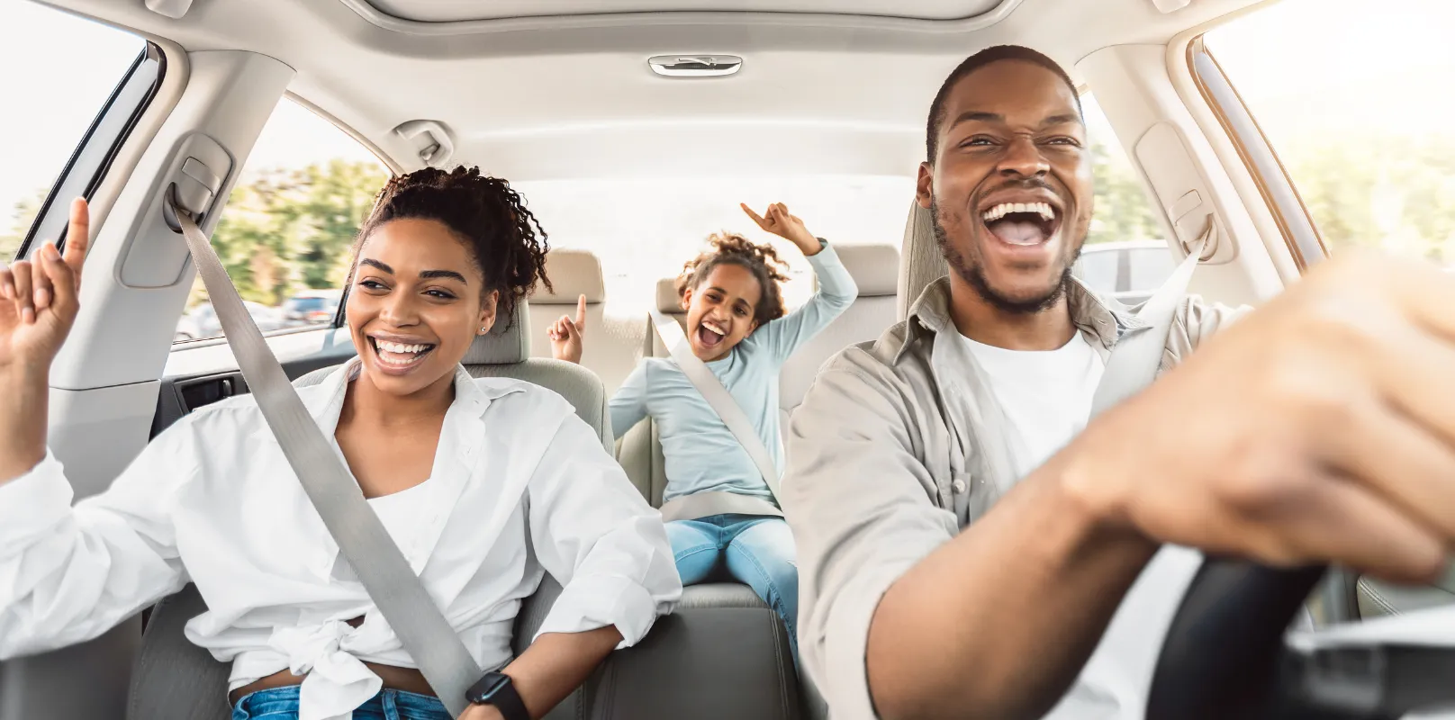 Family enjoying a safe car ride, highlighting the importance of auto insurance protection.