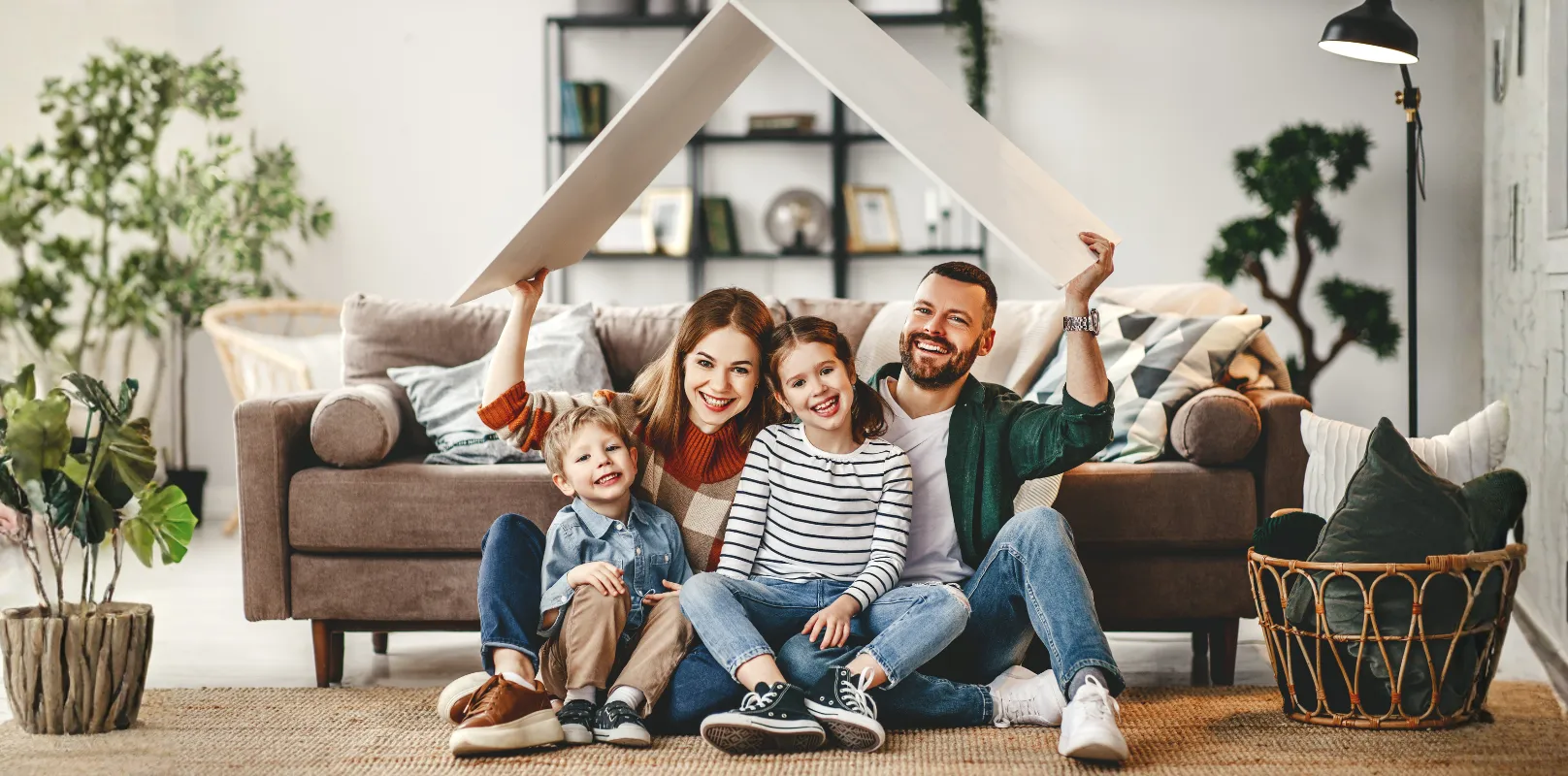 A joyful family sitting comfortably inside their rental property, symbolizing peace of mind provided by comprehensive rental property insurance.