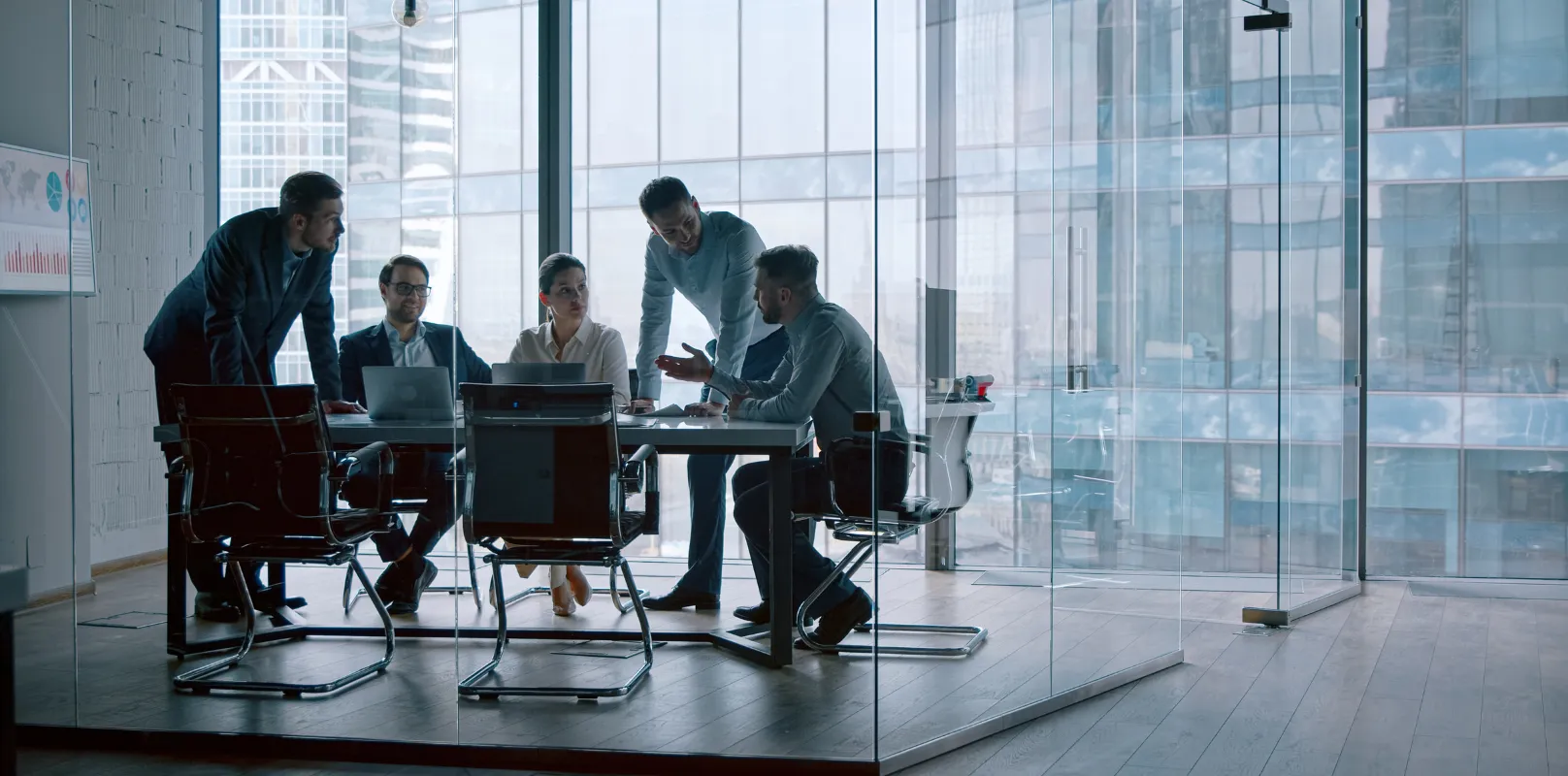 Corporate team meeting in a modern office discussing cybersecurity insurance and data protection planning.